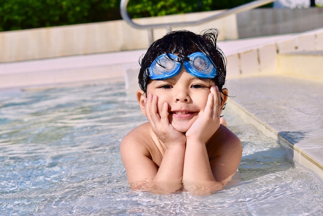 smiling child wearing swim goggles