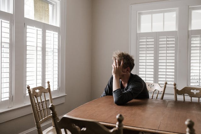 stressed man sitting at table